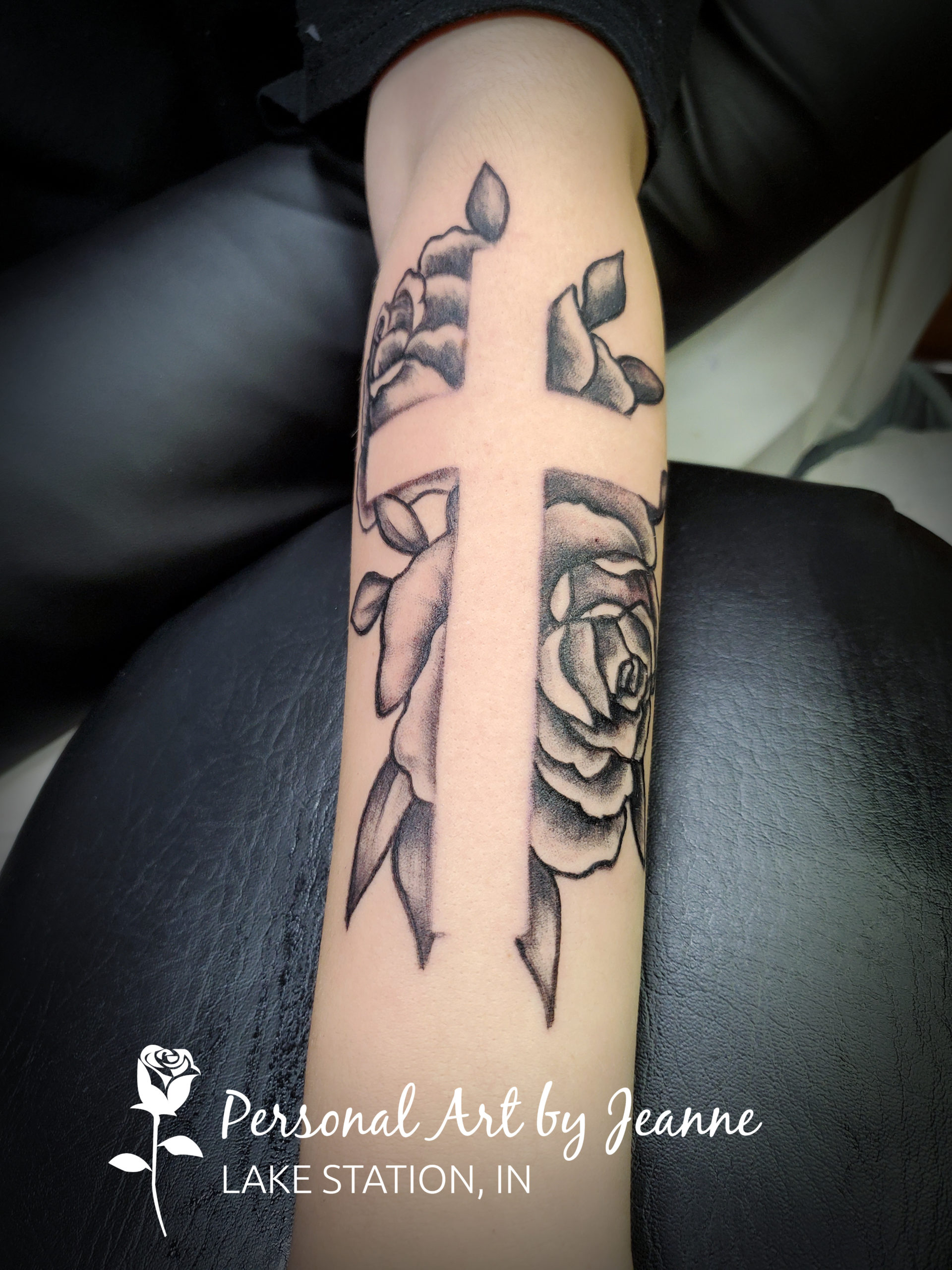 black and gray style rose tattoo with superimposed image of a cross
